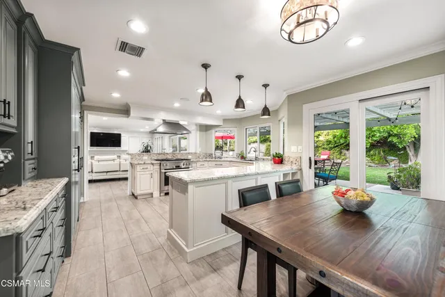 a kitchen with a table chairs and a stove