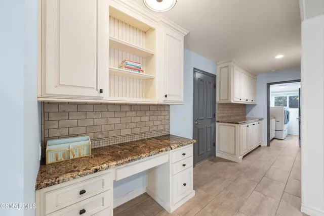 a kitchen with stainless steel appliances granite countertop a stove and a refrigerator