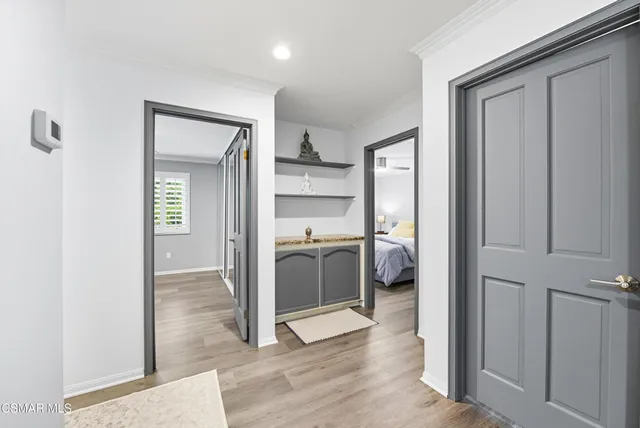a view of a hallway and a livingroom with furniture