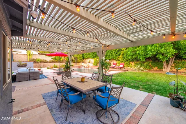 a outdoor space with a table tennis table and chairs