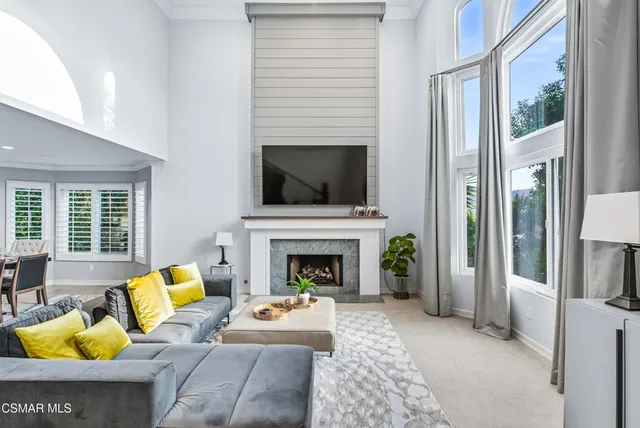 a living room with furniture fireplace and flat screen tv