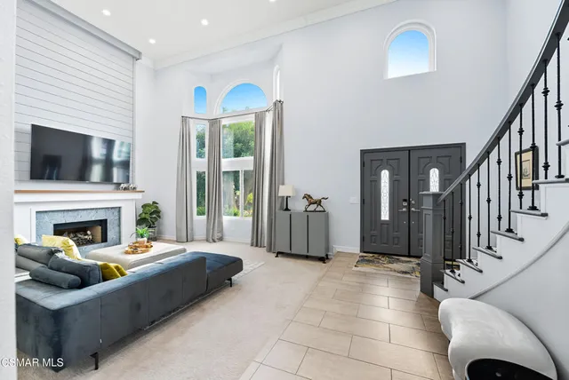 a living room with furniture a fireplace and a flat screen tv