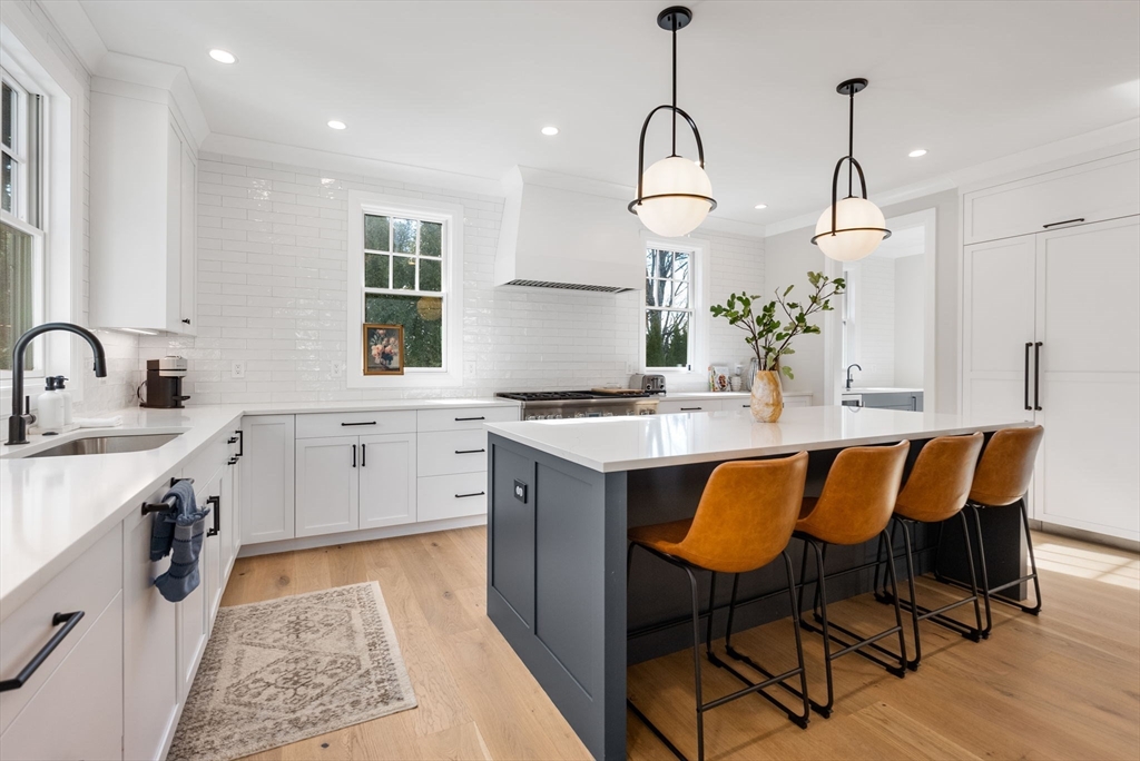 11 Shaw Road Wellesley, MA 02481 - Photo 2 of 22 a kitchen with stainless steel appliances granite countertop sink wooden cabinets and counter top space
