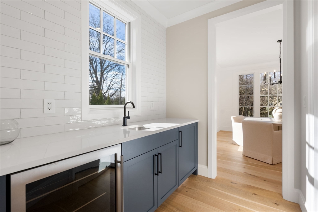 11 Shaw Road Wellesley, MA 02481 - Photo 5 of 22 a bathroom with a sink and a large mirror