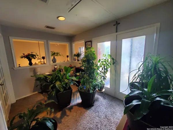 a view of a chairs and table in the patio
