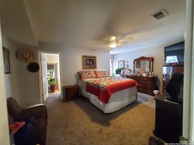 a bedroom with a bed and dresser with mirror