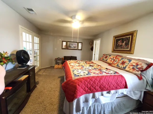 a bedroom with a bed and a couch