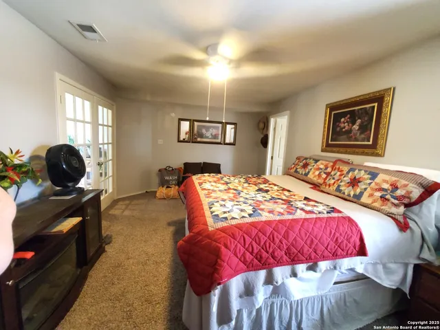 a bedroom with a bed and a couch