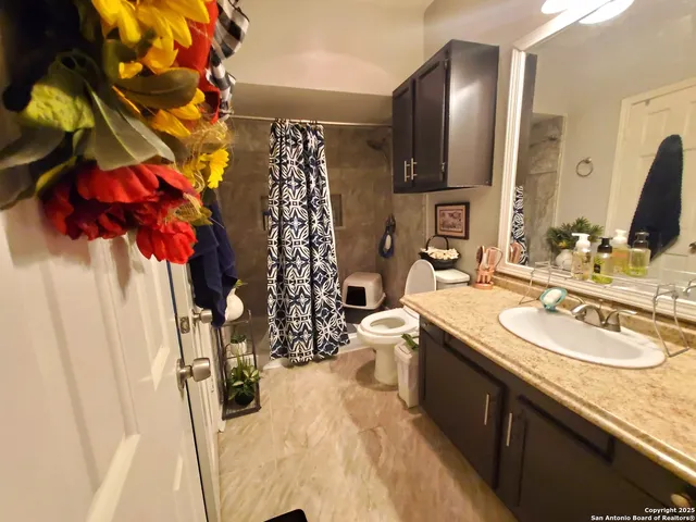 a bathroom with a sink vanity granite and a mirror