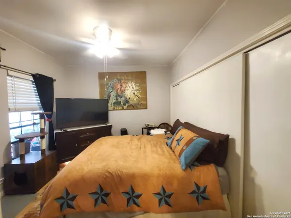 a bedroom with a bed and wooden floor