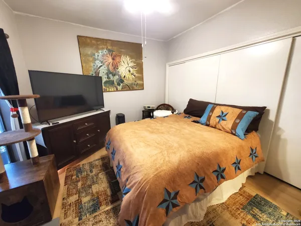 a bedroom with a bed and flat screen tv