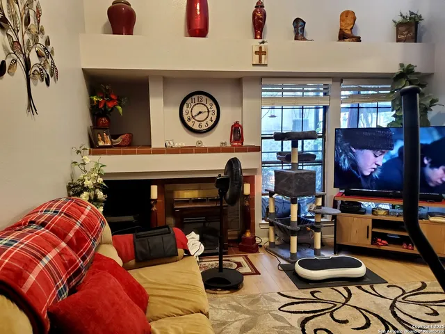 a living room with furniture and a fireplace