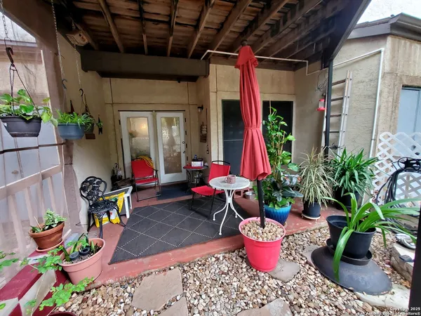a view of a dining room with furniture and a potted plant