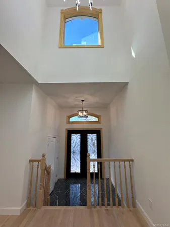 a view of a hallway with wooden floor and a fireplace