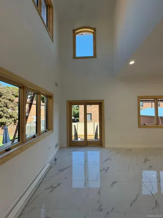 a large kitchen with stainless steel appliances granite countertop a large counter top a sink and a stove