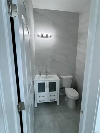 a white toilet sitting next to a bathroom sink