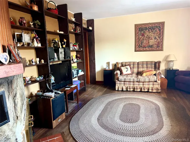 a living room with furniture a fireplace and walls