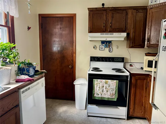 a hallway with a refrigerator and a stove
