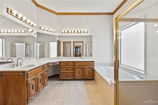 a bathroom with a granite countertop double vanity sink and a mirror