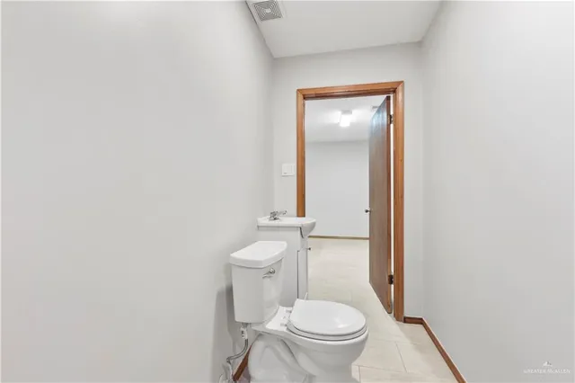 a white toilet sitting next to a bathroom sink