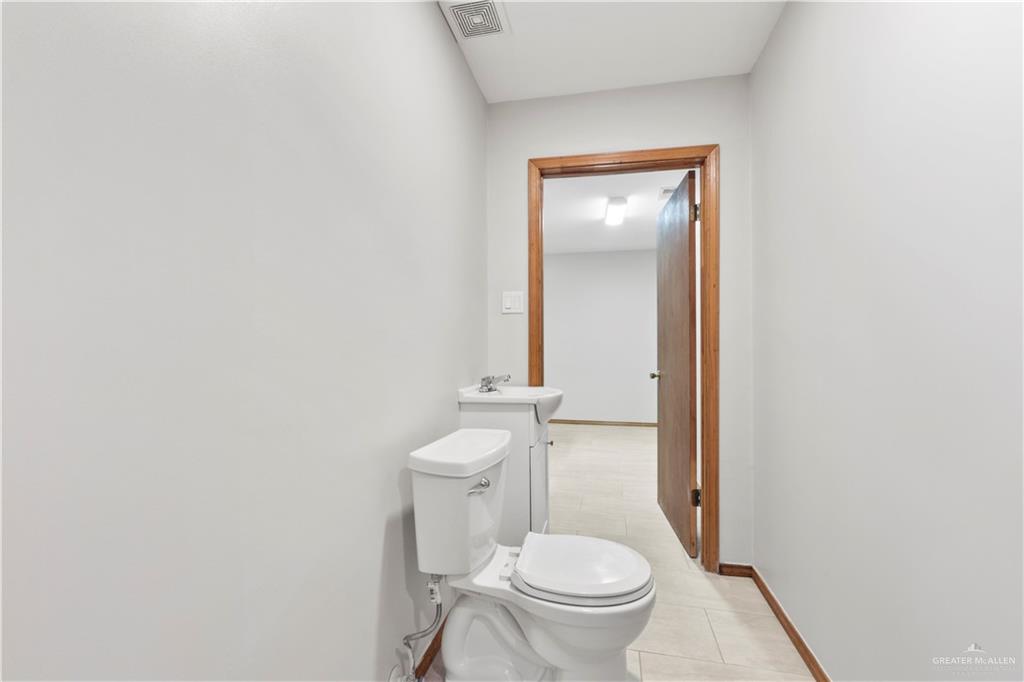 814 Rio Grande Drive Mission, TX 78572 - Photo 20 of 29 a white toilet sitting next to a bathroom sink