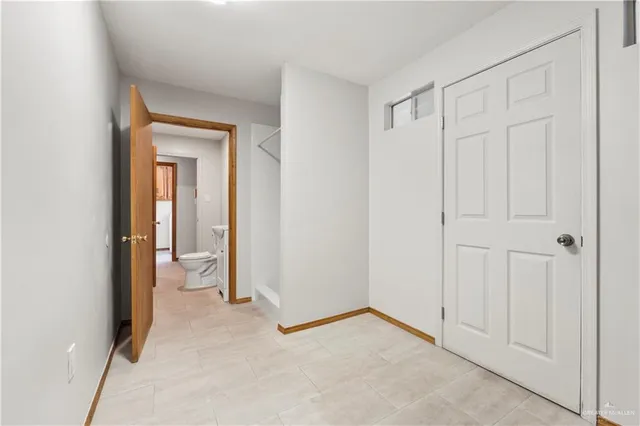 a view of a room with an empty space and wooden floor
