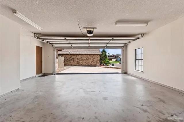 a view of an empty room and a fireplace