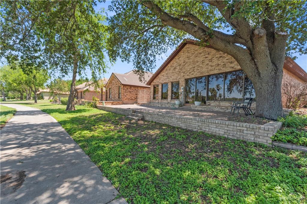 814 Rio Grande Drive Mission, TX 78572 - Photo 28 of 29 a front view of a house with a yard and trees