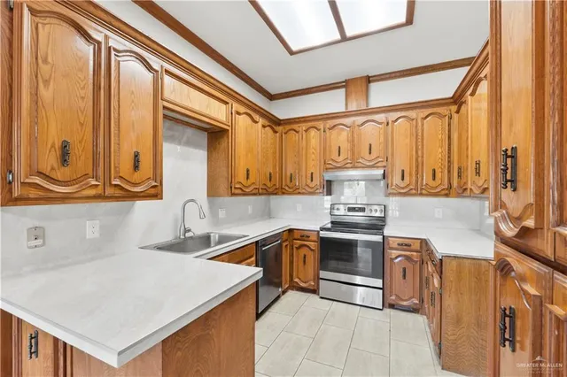 a kitchen with stainless steel appliances granite countertop a sink and a stove