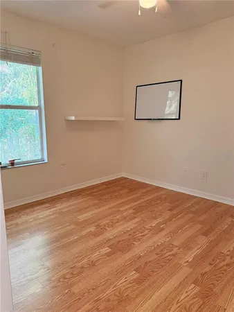 a view of a room with wooden floor and windows