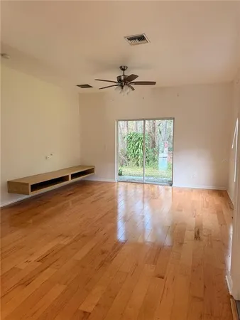 a view of a room with wooden floor and windows