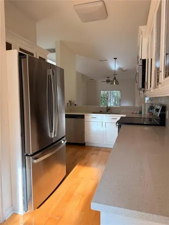 a kitchen with stainless steel appliances a refrigerator and a sink