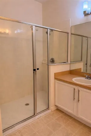a bathroom with a shower and a sink