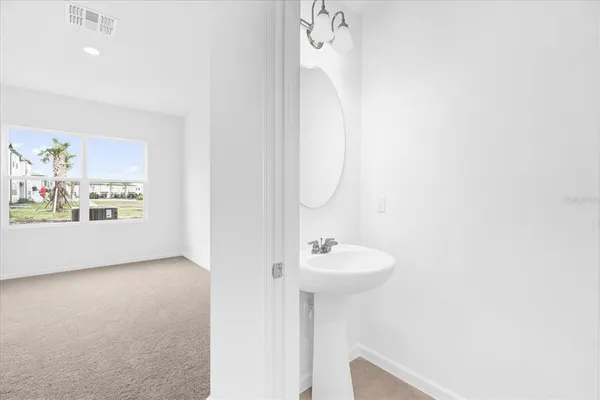 a bathroom with a sink a mirror and a toilet