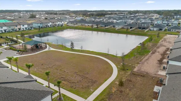 an aerial view of a house with outdoor space and lake view