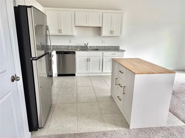 a kitchen with a stove a refrigerator and a sink