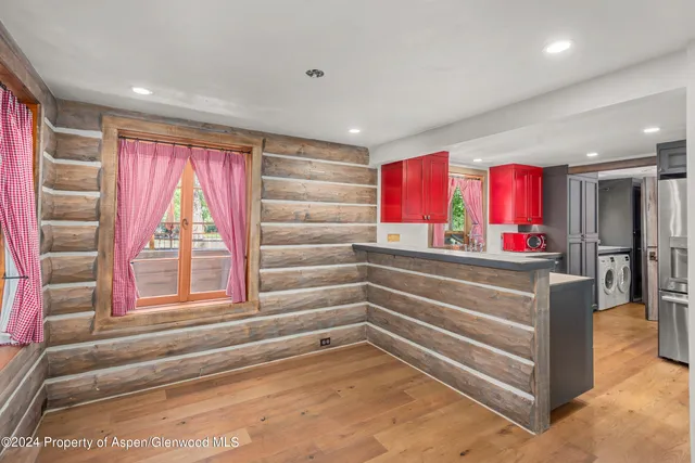 an aerial view of a house with swimming pool and garden