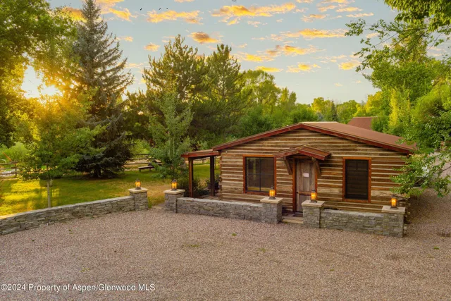 a view of a deck with chairs and wooden fence