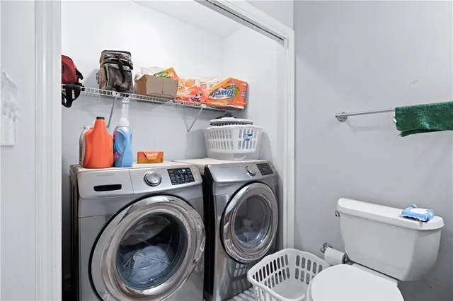 a view of a storage and utility room with washer and dryer