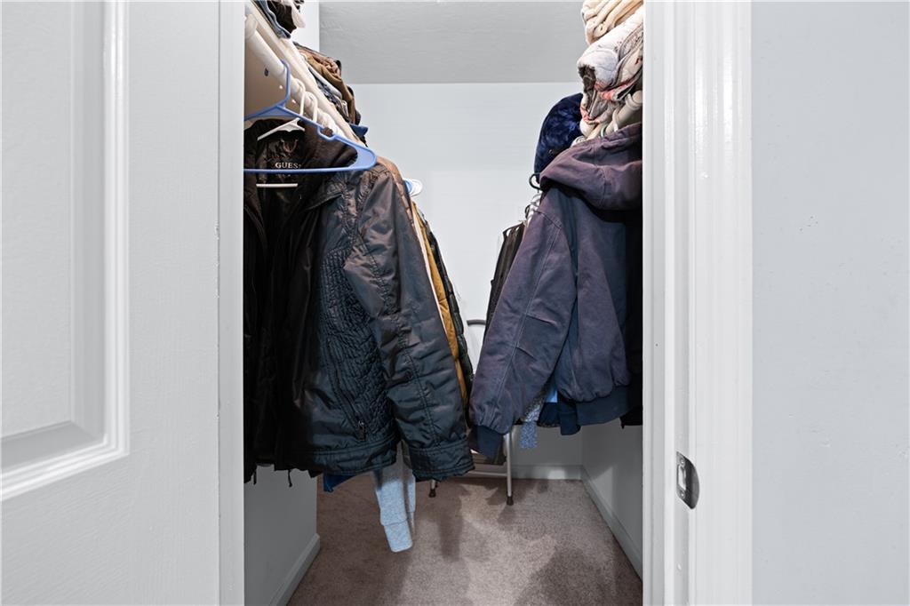 237 Chads Ford Way Roswell, GA 30076 - Photo 13 of 22 a view of walk in closet with clothes