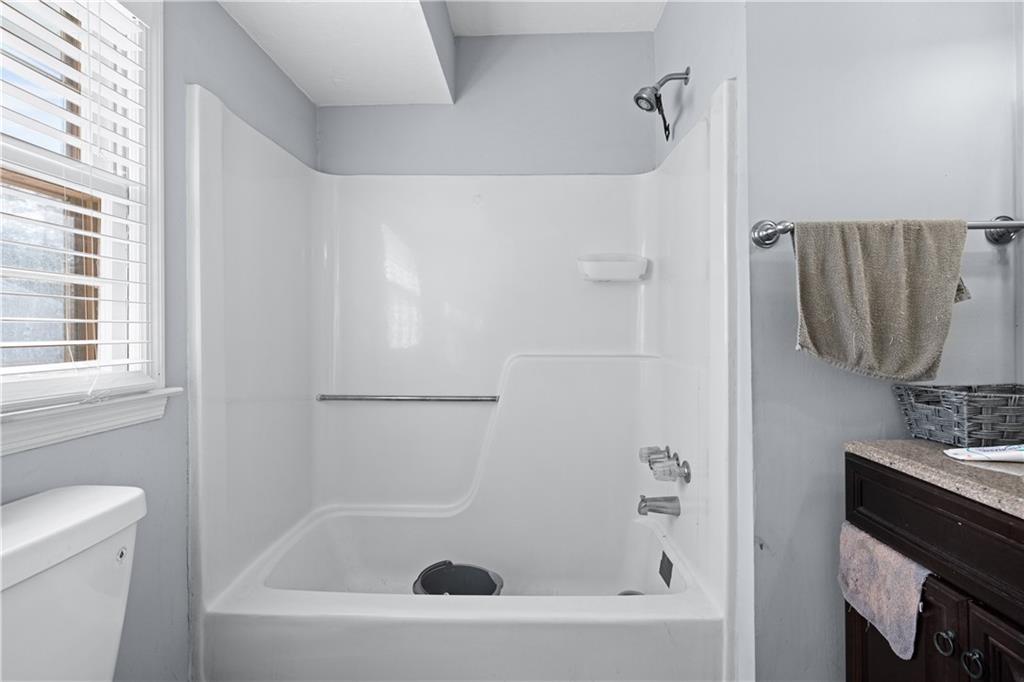 237 Chads Ford Way Roswell, GA 30076 - Photo 17 of 22 a bathroom with a bathtub and a shower