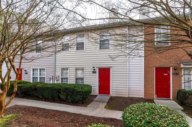 a front view of a house with yard and green space