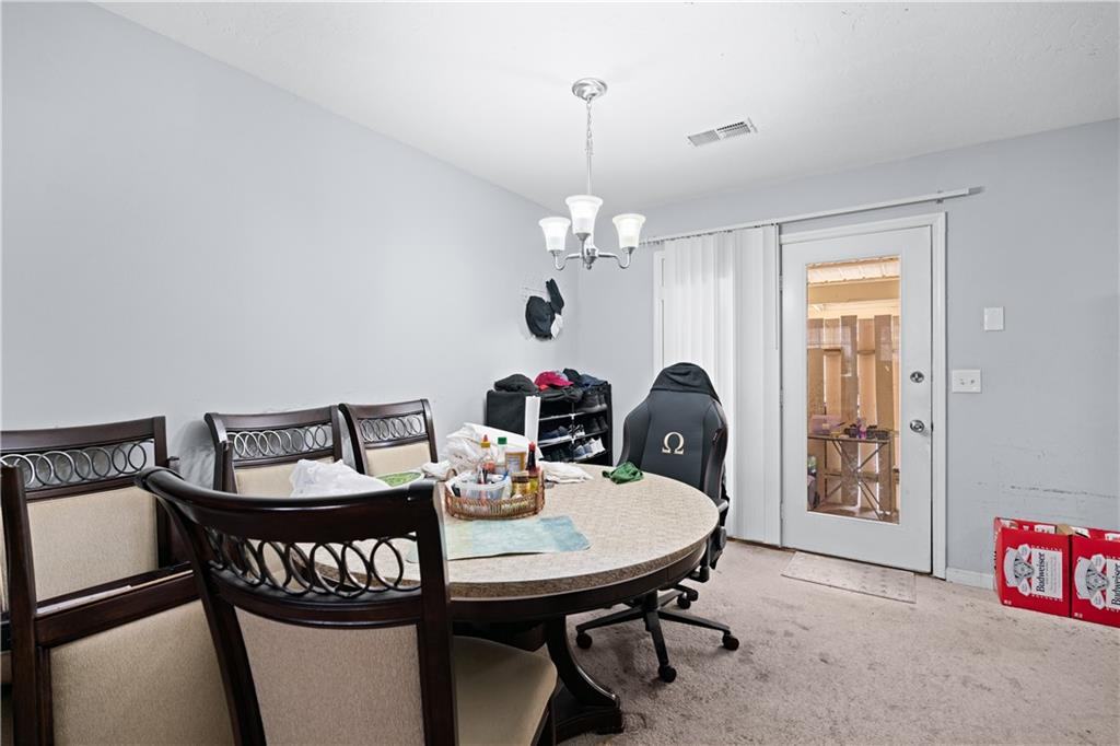 237 Chads Ford Way Roswell, GA 30076 - Photo 6 of 22 a view of a dining room with furniture and chandelier