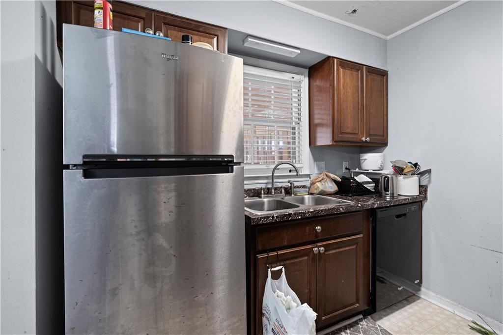 237 Chads Ford Way Roswell, GA 30076 - Photo 8 of 22 a kitchen with granite countertop a sink and a refrigerator