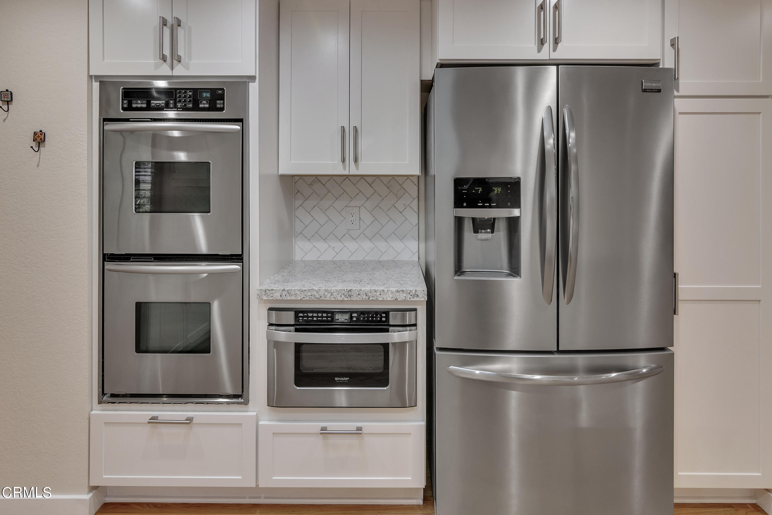 524 Franklin Place Monrovia, CA 91016 - Photo 11 of 33 a metallic refrigerator freezer and a stove sitting inside of a kitchen