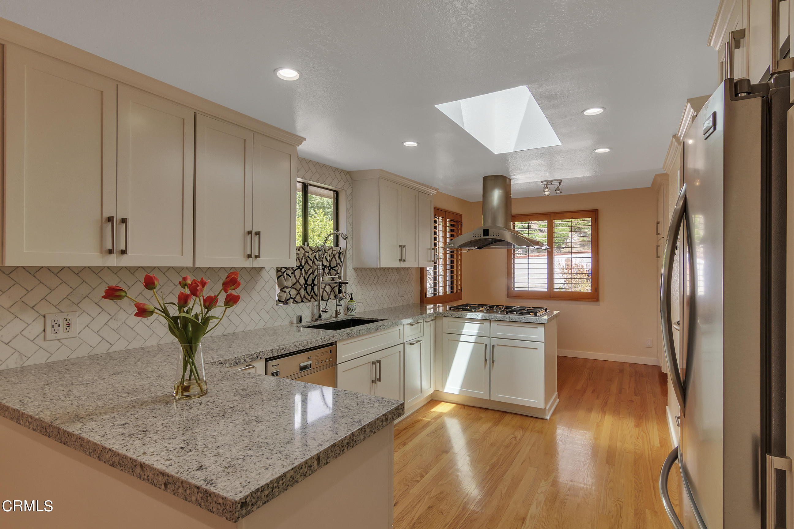 524 Franklin Place Monrovia, CA 91016 - Photo 9 of 33 a kitchen with stainless steel appliances granite countertop a sink a stove and a wooden floors