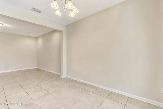 an empty room with kitchen view