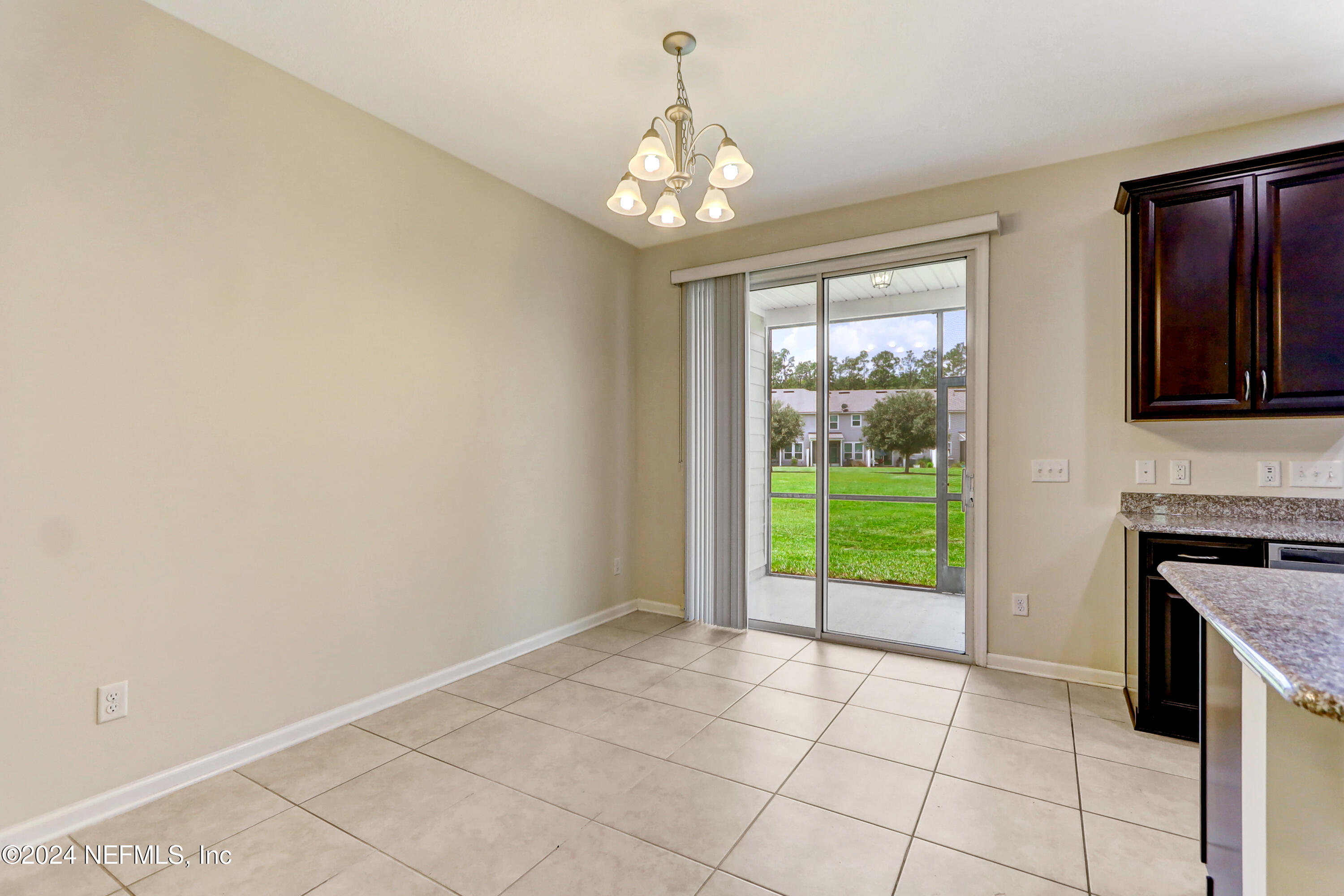 95 Nelson Lane St. Johns, FL 32259 - Photo 13 of 30 a view of an empty room with window and kitchen view