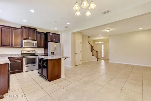 a view of kitchen with stainless steel appliances cabinets and a counter top space