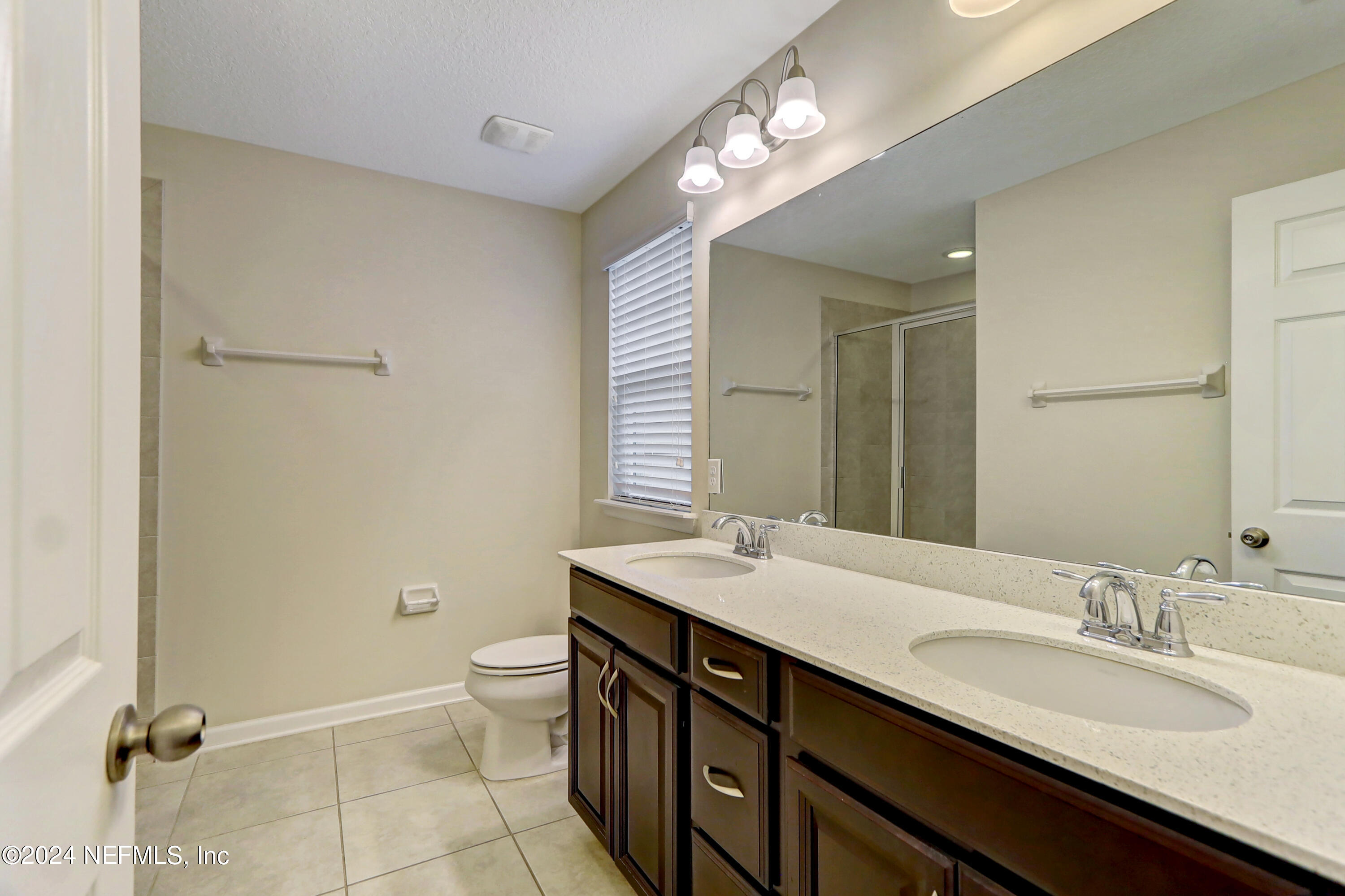 95 Nelson Lane St. Johns, FL 32259 - Photo 21 of 30 a bathroom with a double vanity sink toilet and a mirror